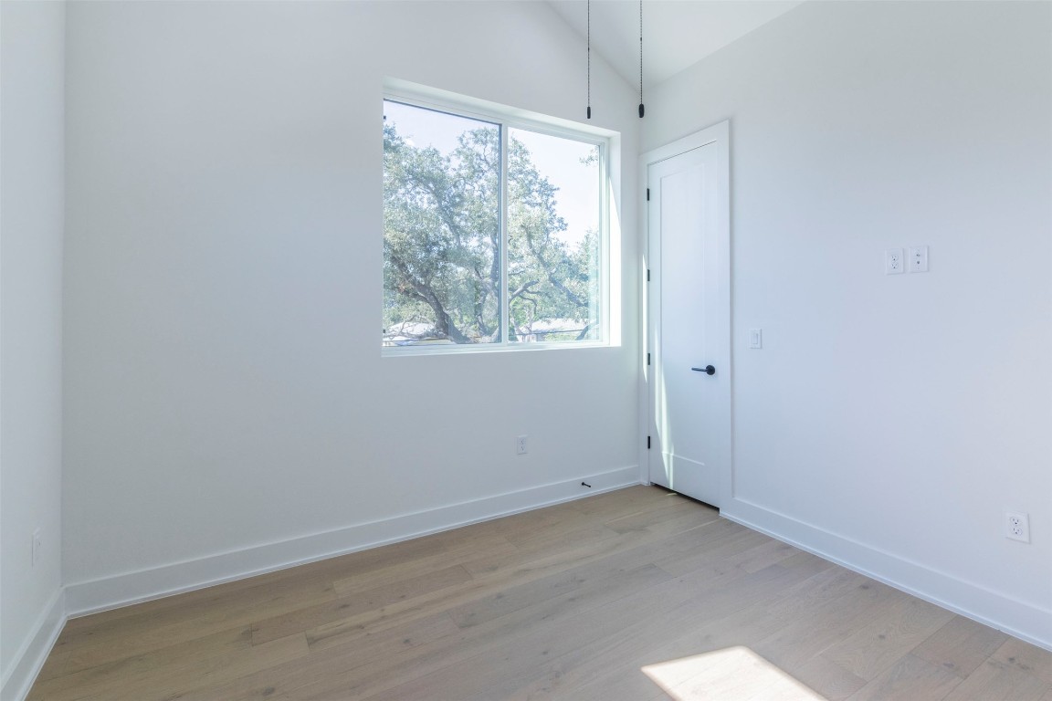 3600 Pennsylvania Avenue, Unit 2 Austin, TX 78721 - Photo 14 of 23 an empty room with wooden floor and windows