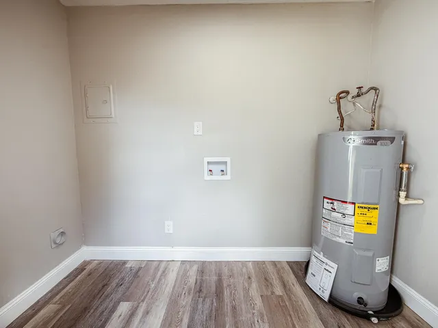 a view of a room with wooden floor and a bathroom