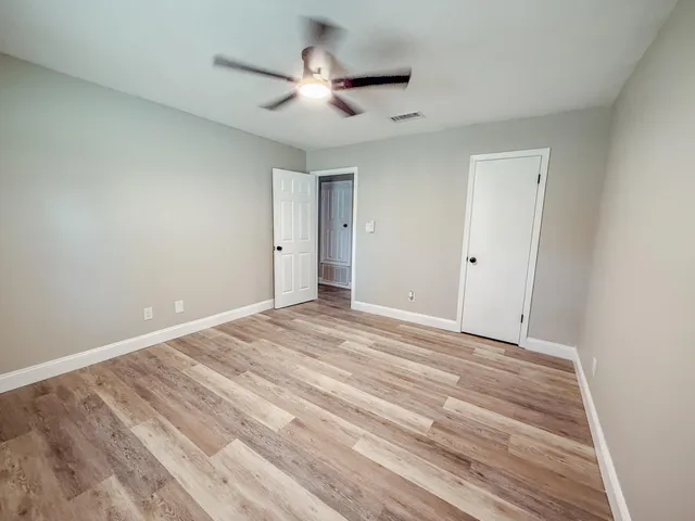 a view of a room with a ceiling fan
