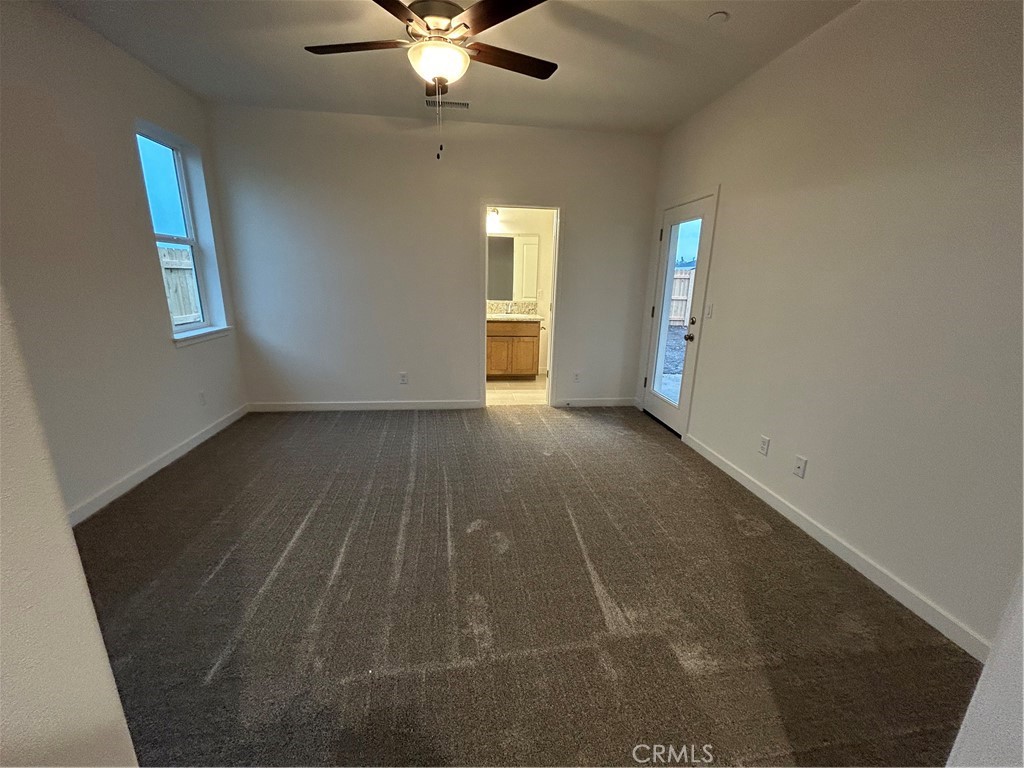 352 Gladstone Chico, CA 95973 - Photo 14 of 22 an empty room with chandelier fan and windows