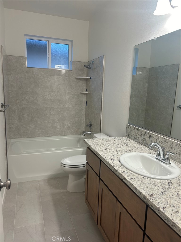 352 Gladstone Chico, CA 95973 - Photo 5 of 22 a bathroom with a granite countertop sink a toilet and bathtub