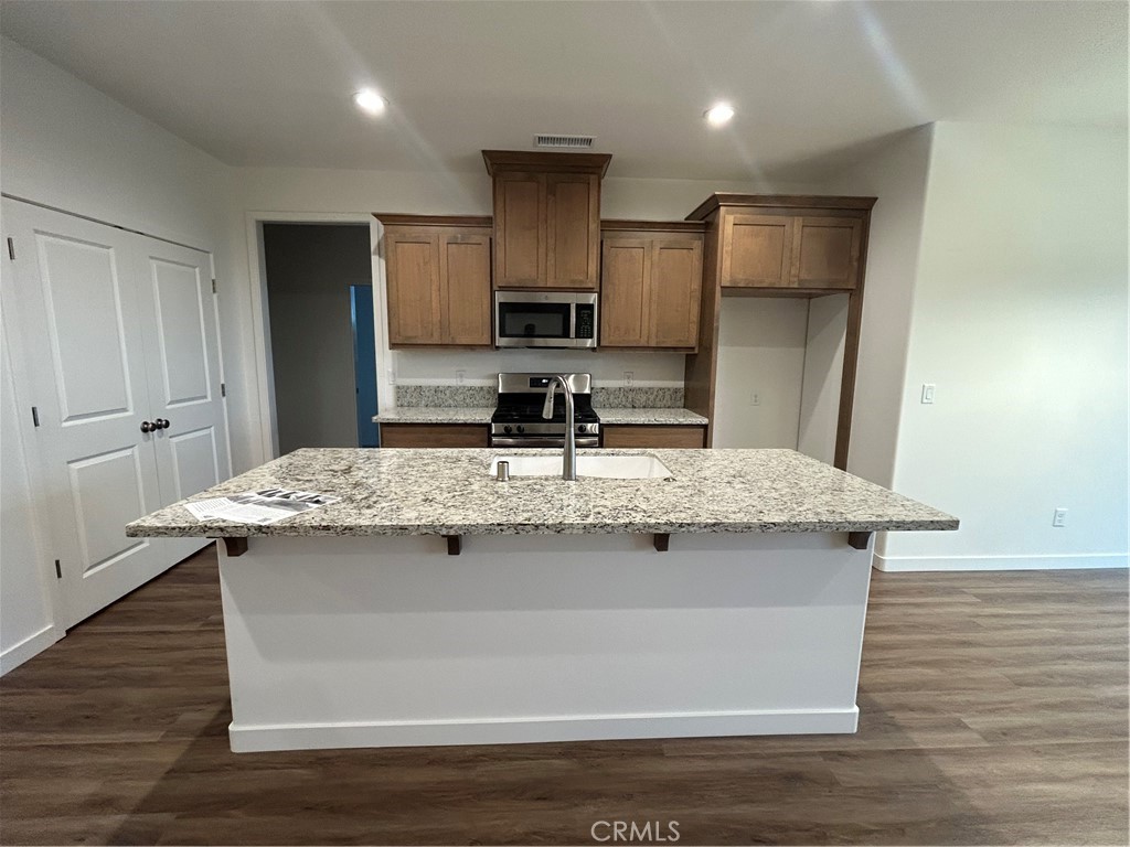 352 Gladstone Chico, CA 95973 - Photo 7 of 22 a kitchen with kitchen island granite countertop a sink and refrigerator