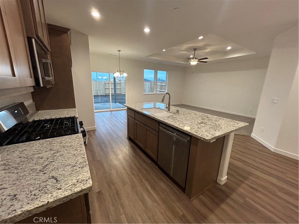 352 Gladstone Chico, CA 95973 - Photo 9 of 22 a kitchen with stainless steel appliances granite countertop wooden cabinets a sink and a stove