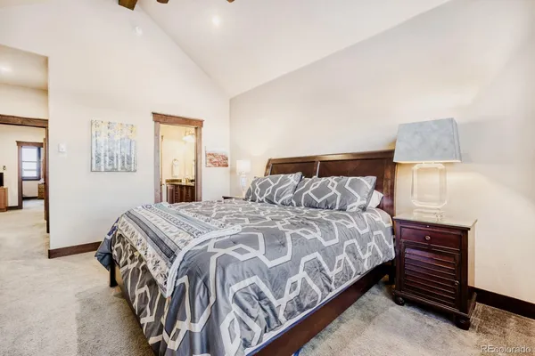 a bedroom with a bed and a lamp