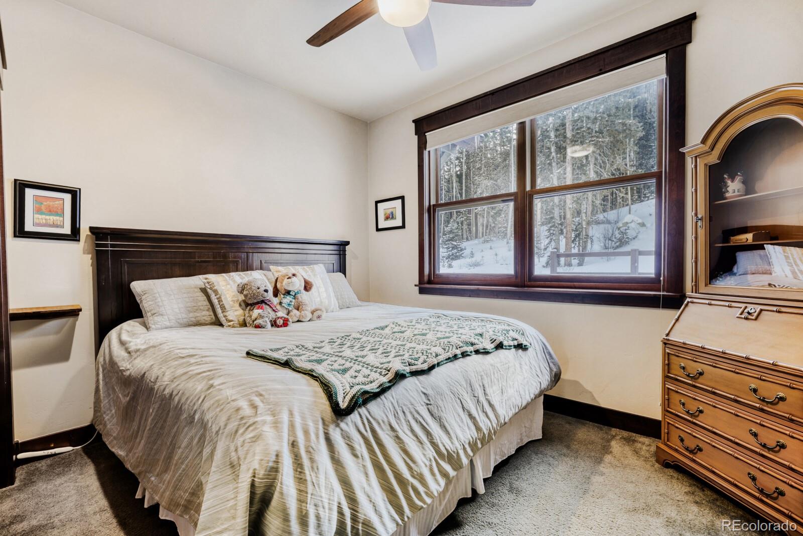 0852 Independence Road Dillon, CO 80435 - Photo 22 of 43 a bedroom with a bed and a dresser next to a window