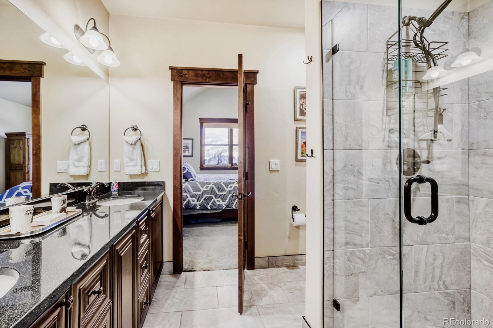 0852 Independence Road Dillon, CO 80435 - Photo 23 of 43 a en suite bathroom with a shower sink and mirror