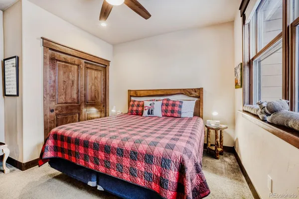 a bedroom with a bed and a large window