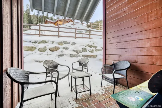 a view of a chairs and table in the balcony