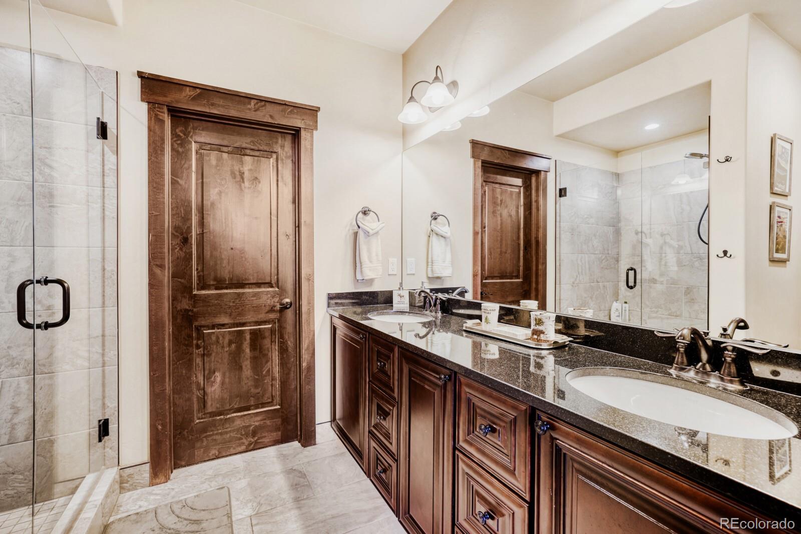 0852 Independence Road Dillon, CO 80435 - Photo 5 of 43 a bathroom with a double vanity sink a and mirror