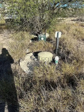 a view of a yard with wooden fence