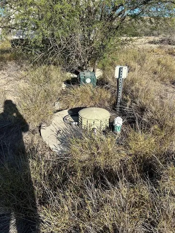 a view of a yard with wooden fence
