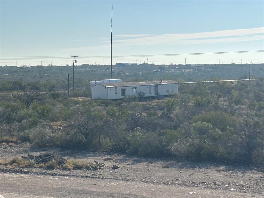 133 Brite Road Del Rio, TX 78840 - Photo 5 of 5 a view of a dry yard with wooden fence