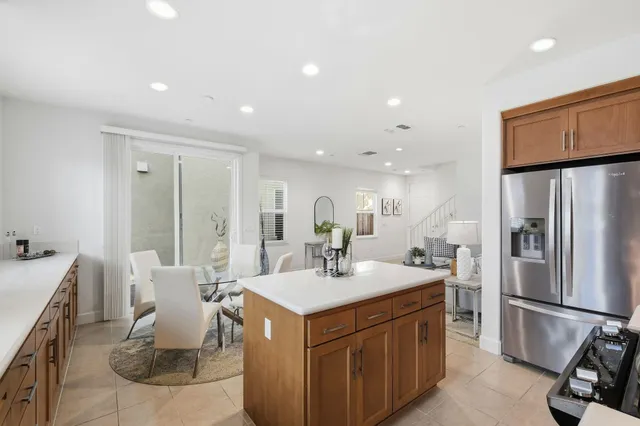 a kitchen with kitchen island a sink appliances and a counter top space