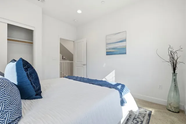 a bedroom with a bed and a lamp