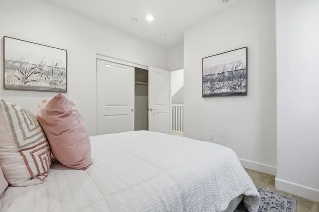 a bedroom with a bed and a wall painting