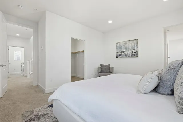 a bedroom with a bed and a painting