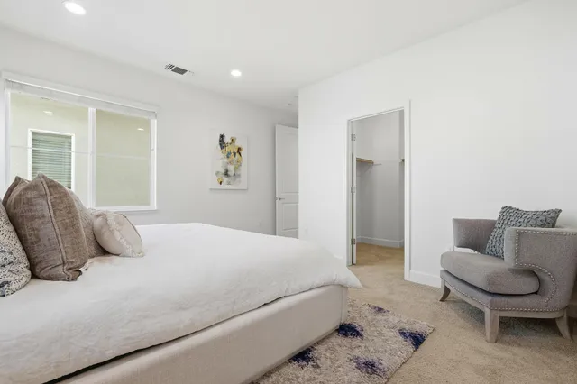 a bedroom with a bed and a couch