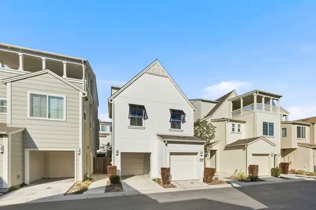 a view of a white house with large windows