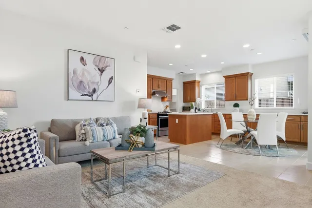 a living room with furniture kitchen view and a table