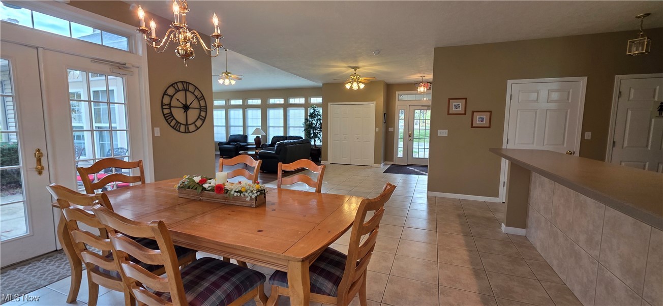 5645 Clingan Road, Unit 23B Struthers, OH 44471 - Photo 38 of 38 Dining area with light tile patterned flooring, ceiling fan, and a chandelier