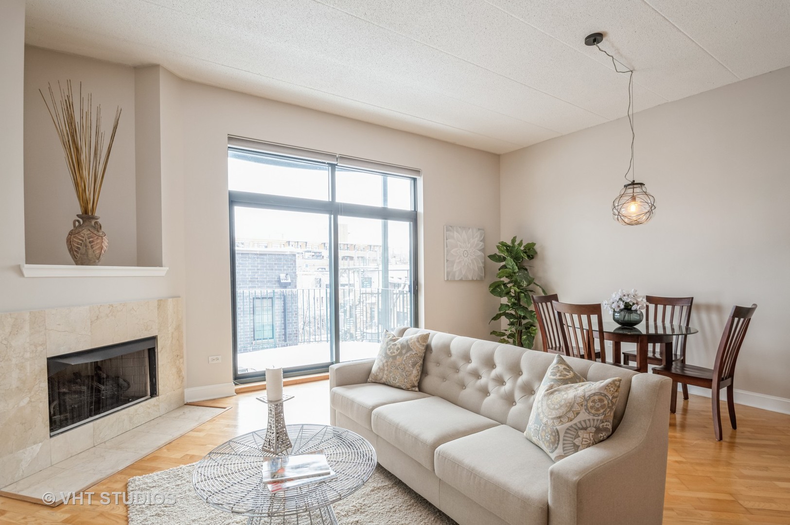 1301 West Washington Boulevard, Unit 405 Chicago, IL 60607 - Photo 2 of 10 a living room with furniture a fireplace and a floor to ceiling window