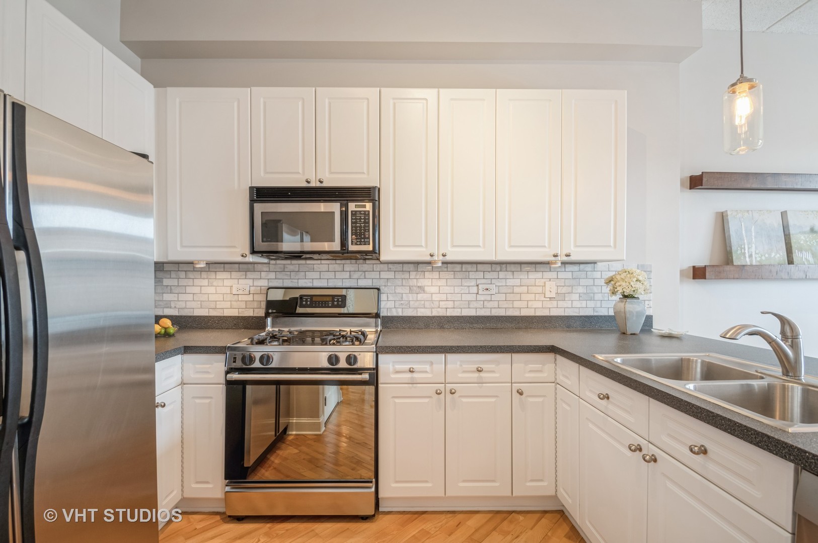 1301 West Washington Boulevard, Unit 405 Chicago, IL 60607 - Photo 4 of 10 a kitchen with granite countertop white cabinets and stainless steel appliances