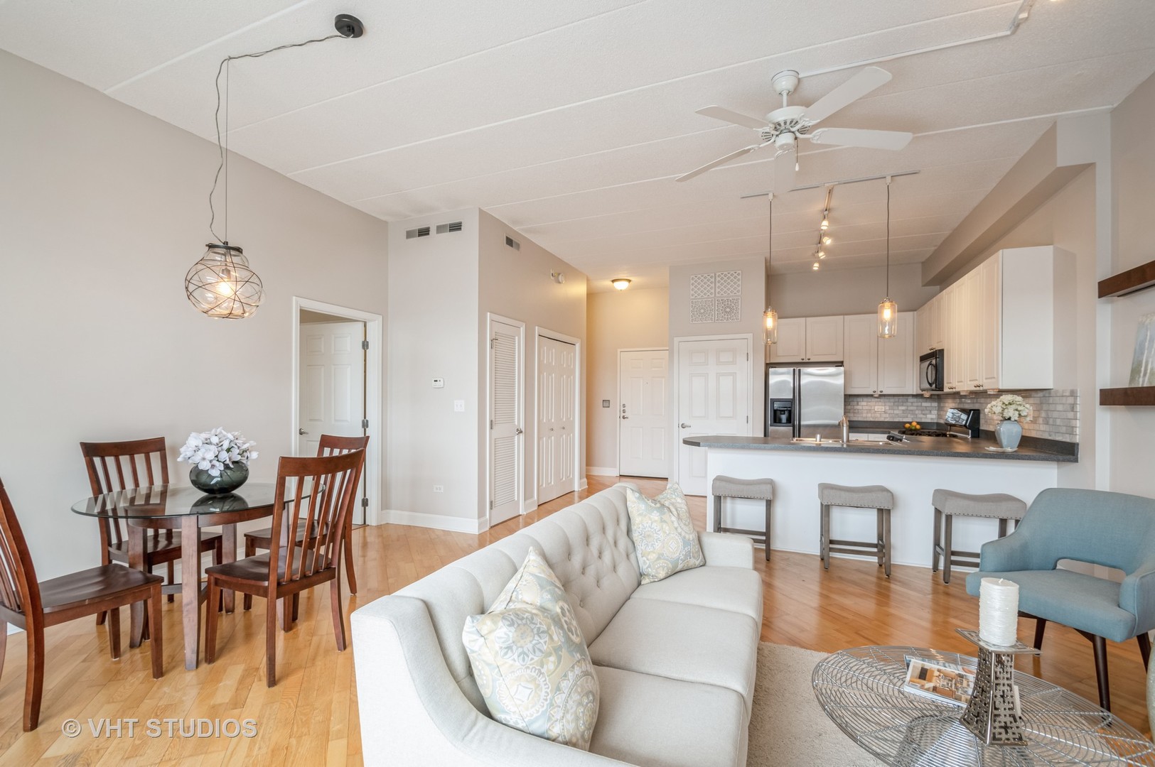 1301 West Washington Boulevard, Unit 405 Chicago, IL 60607 - Photo 6 of 10 a living room with stainless steel appliances kitchen island granite countertop furniture and a dining table