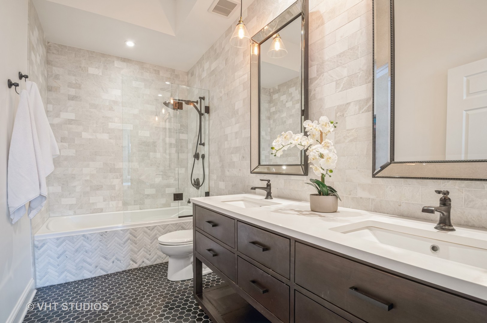 1301 West Washington Boulevard, Unit 405 Chicago, IL 60607 - Photo 9 of 10 a bathroom with a double vanity sink toilet mirror and bathtub