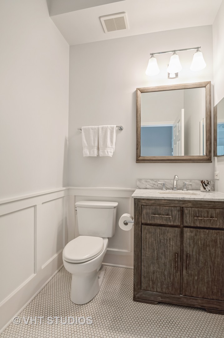 1301 West Washington Boulevard, Unit 405 Chicago, IL 60607 - Photo 10 of 10 a bathroom with a toilet a sink and mirror