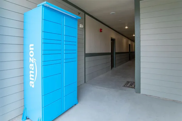 a view of an empty room to empty room and kitchen