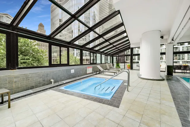 a view of a patio with swimming pool table and chairs