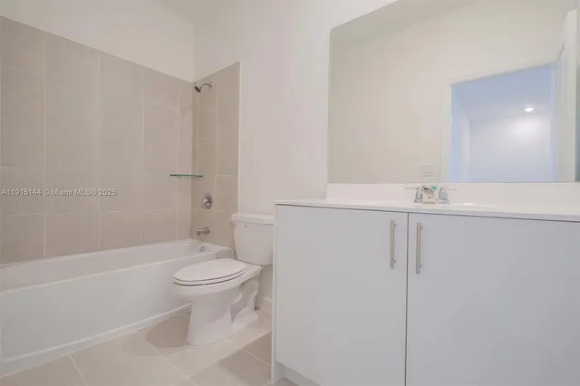 a white toilet sitting next to a bath tub