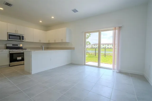 a view of a kitchen with a stove cabinets and a kitchen