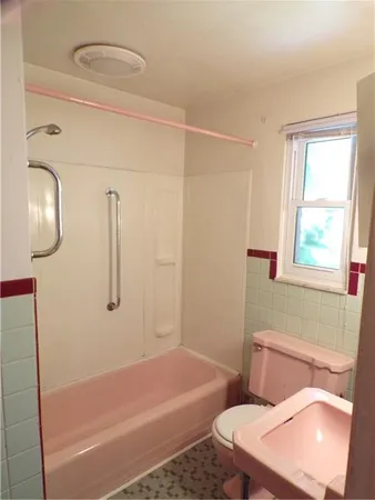a bathroom with a toilet and a bathtub