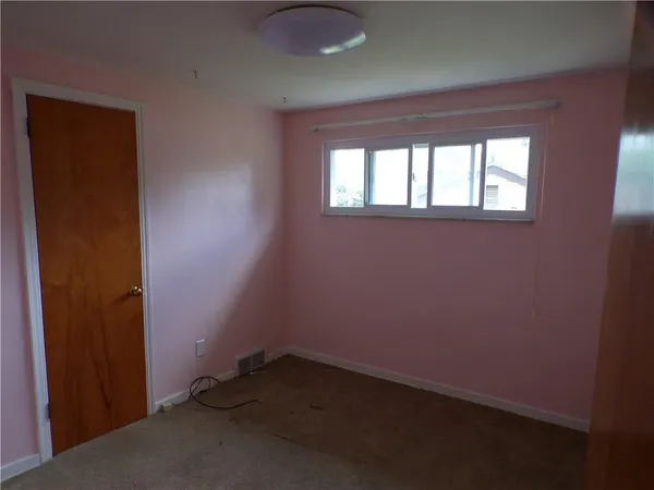 an empty room with a empty space and a window