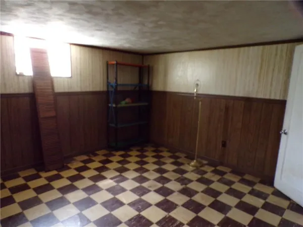 a bathroom with a black and white checkered floor