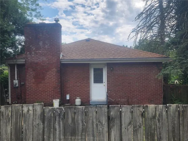 a front view of house with wooden fence