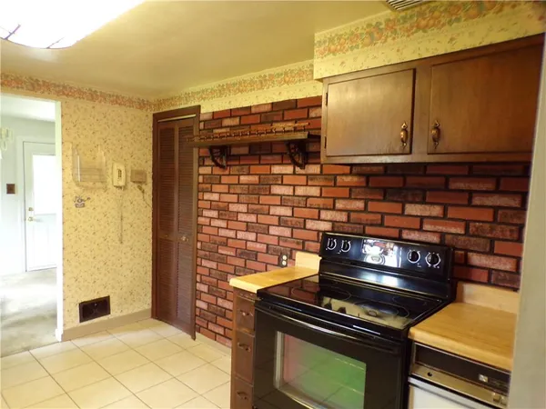 a kitchen with a stove and a cabinet