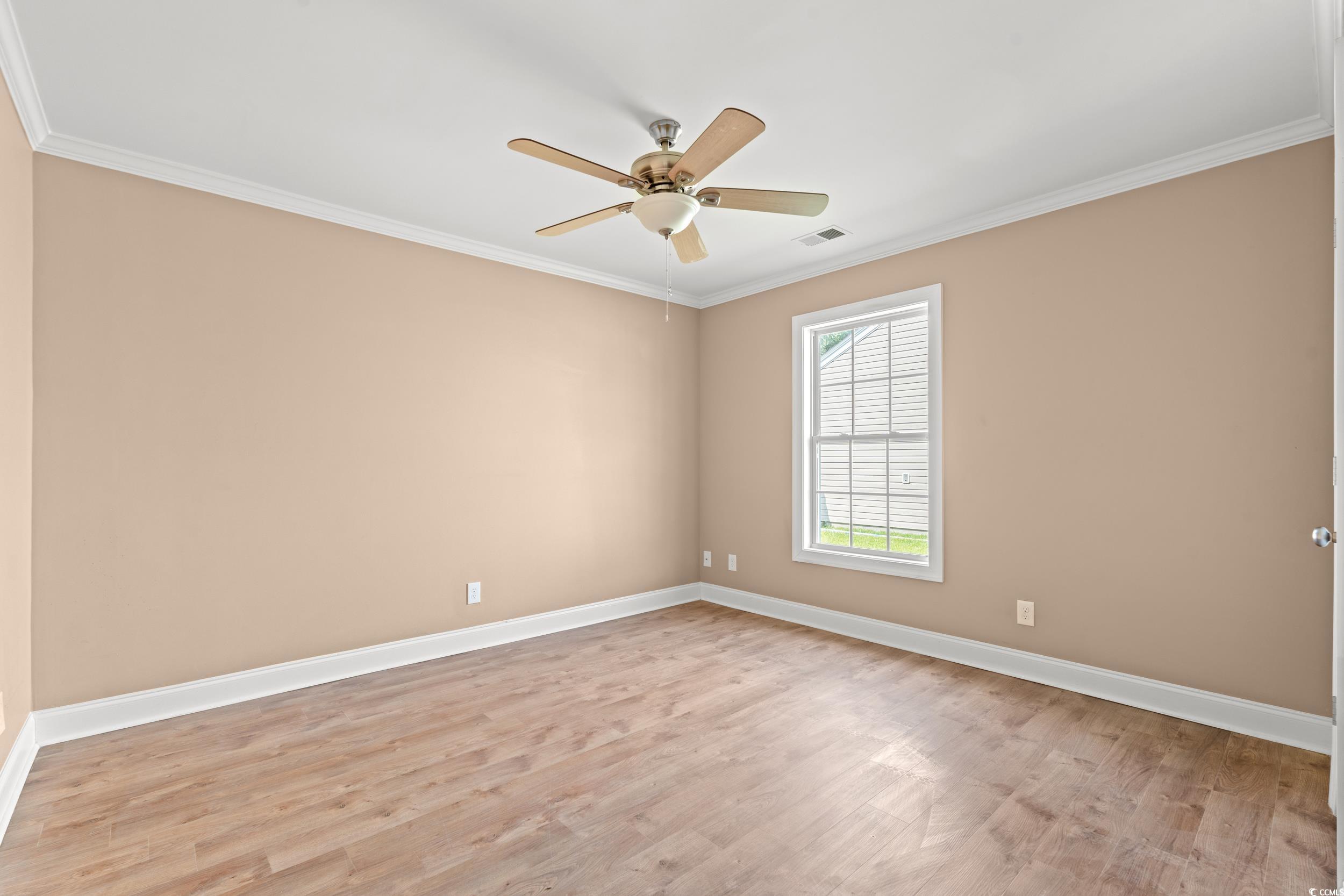 708 Alexis Drive Longs, SC 29568 - Photo 13 of 32 Spare room with light wood-style floors, ceiling fan, and crown molding