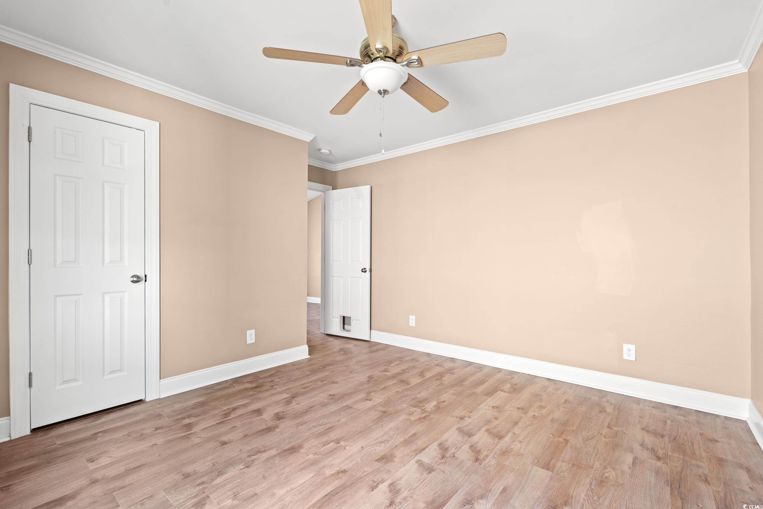 708 Alexis Drive Longs, SC 29568 - Photo 14 of 32 Unfurnished bedroom with crown molding, light wood-type flooring, and a ceiling fan