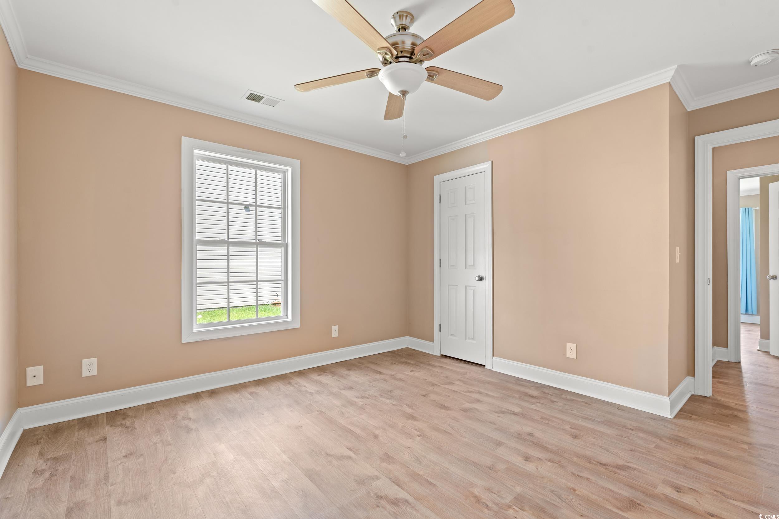 708 Alexis Drive Longs, SC 29568 - Photo 15 of 32 Spare room with crown molding, light wood-style floors, and a ceiling fan