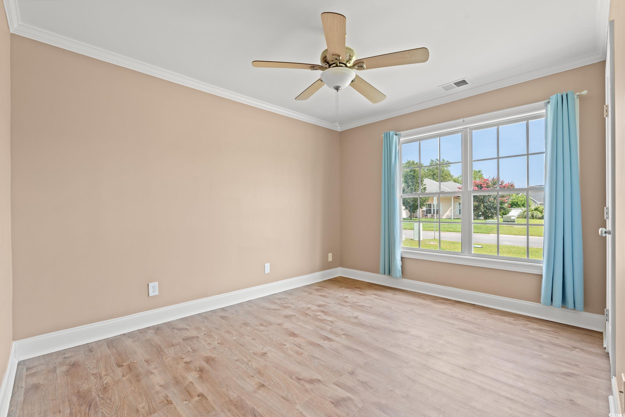 708 Alexis Drive Longs, SC 29568 - Photo 17 of 32 Unfurnished room featuring crown molding, light wood finished floors, and a ceiling fan