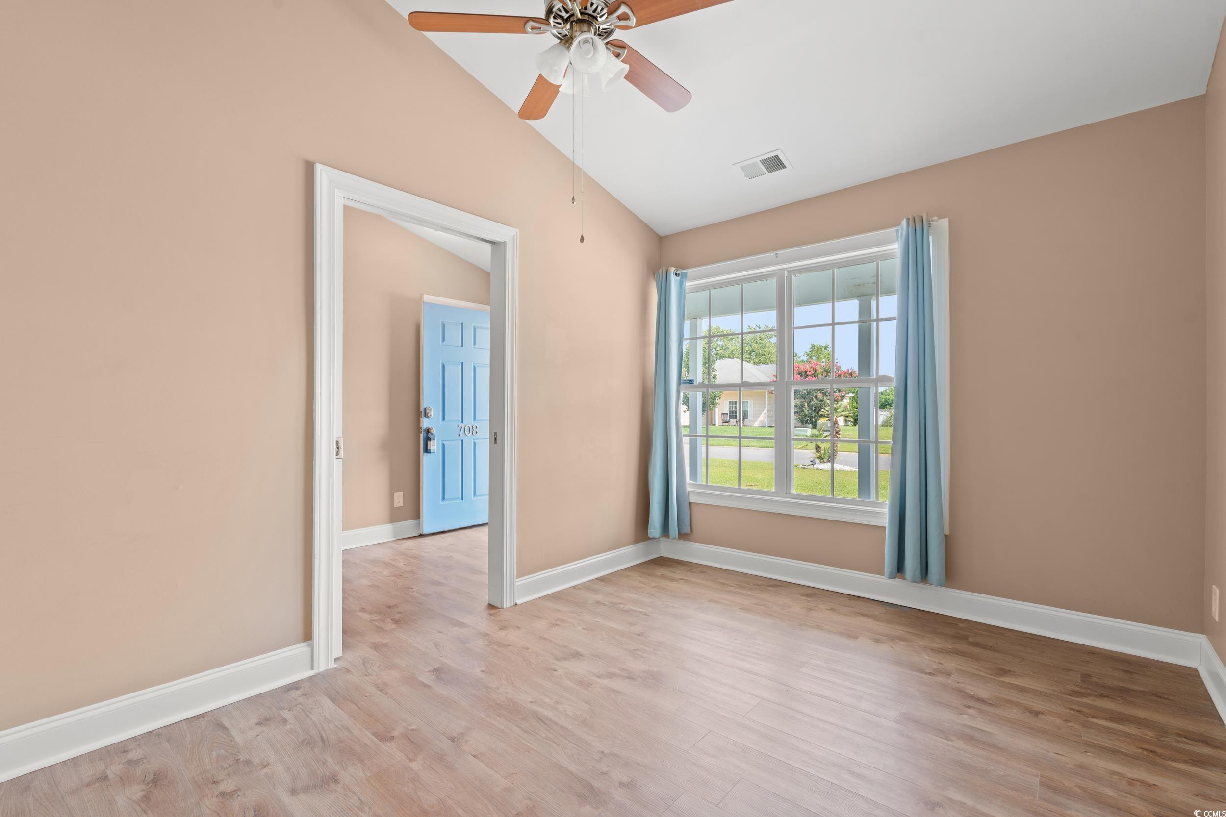 708 Alexis Drive Longs, SC 29568 - Photo 21 of 32 Spare room featuring light wood-type flooring, lofted ceiling, and a ceiling fan