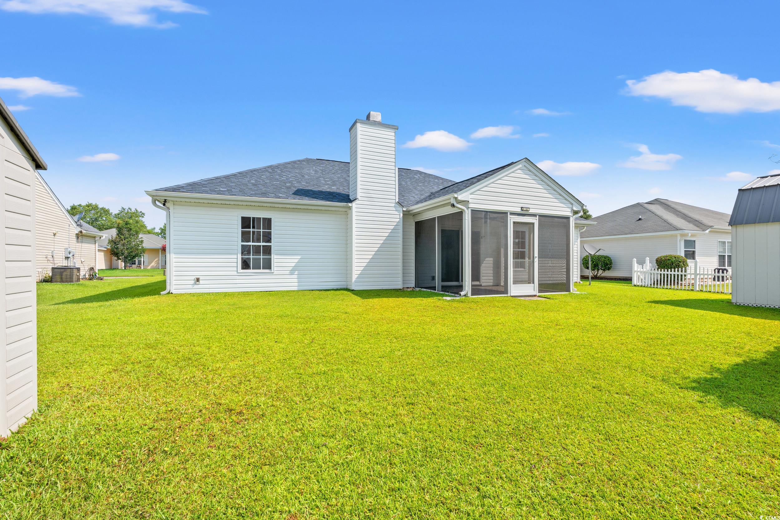 708 Alexis Drive Longs, SC 29568 - Photo 25 of 32 Rear view of property with a chimney, roof with shingles, and a sunroom