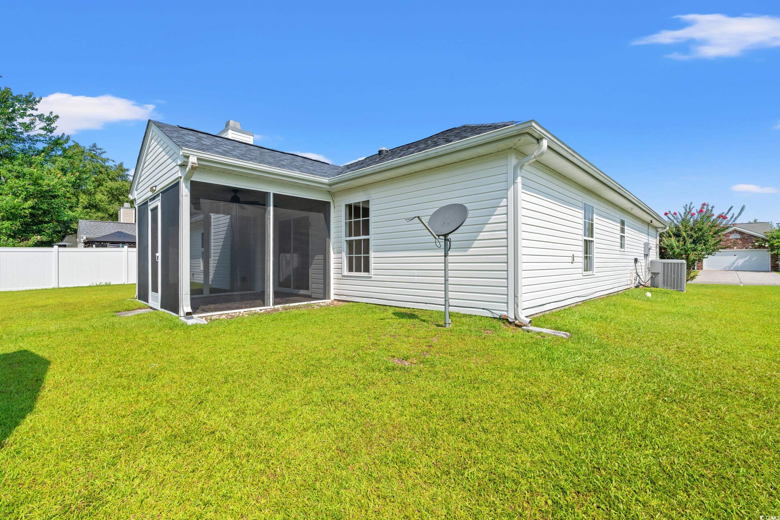 708 Alexis Drive Longs, SC 29568 - Photo 26 of 32 Back of house featuring a sunroom, a chimney, and roof with shingles