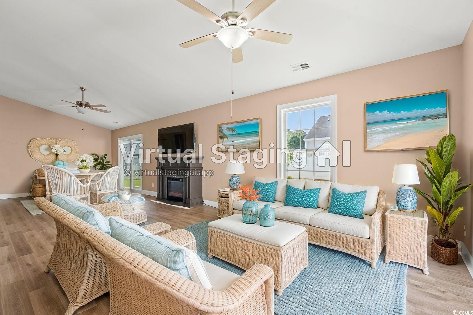 708 Alexis Drive Longs, SC 29568 - Photo 5 of 32 Living area with a glass covered fireplace, a ceiling fan, wood finished floors, and vaulted ceiling