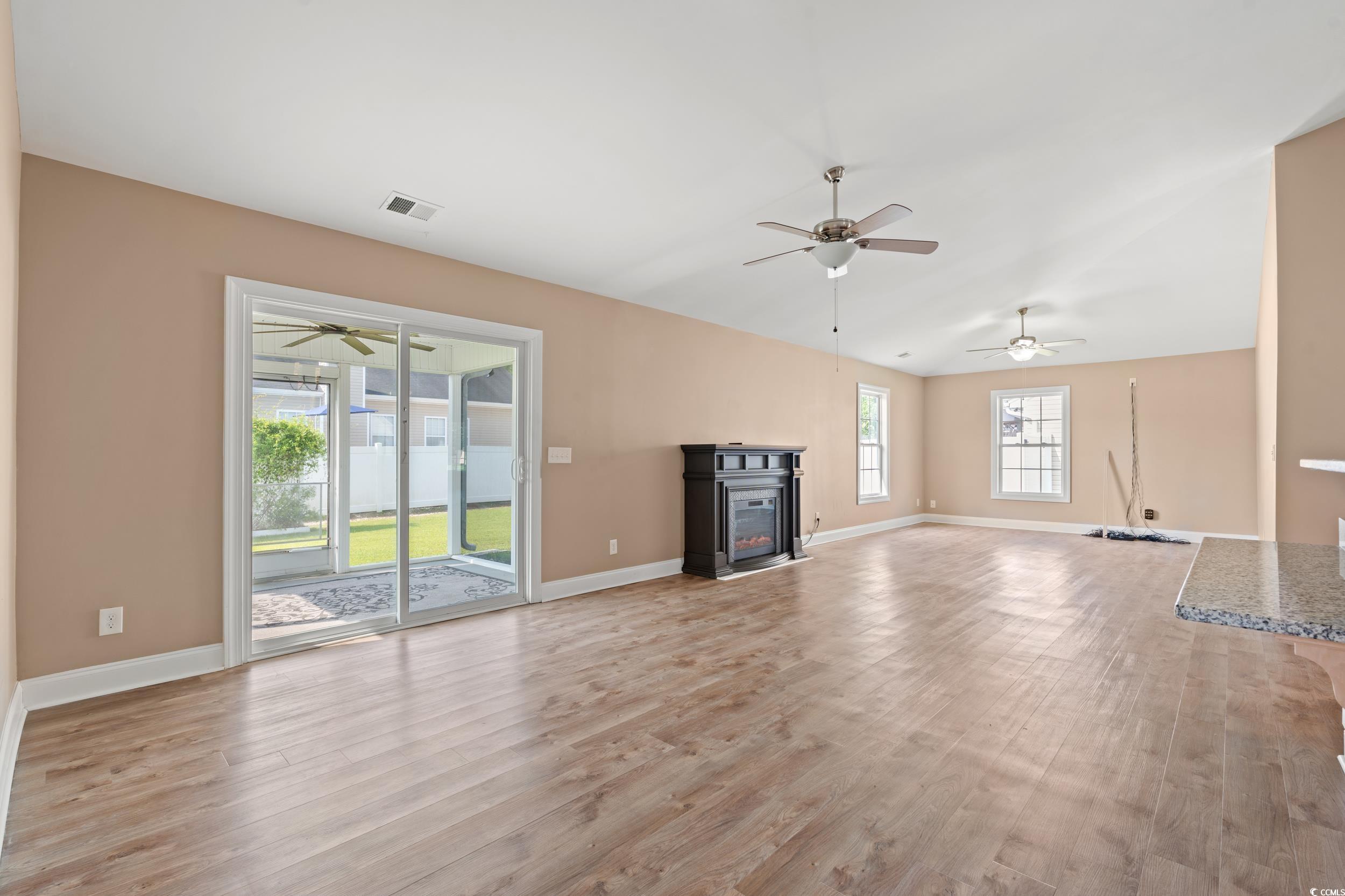 708 Alexis Drive Longs, SC 29568 - Photo 8 of 32 Unfurnished living room with light wood-style flooring, ceiling fan, and a fireplace