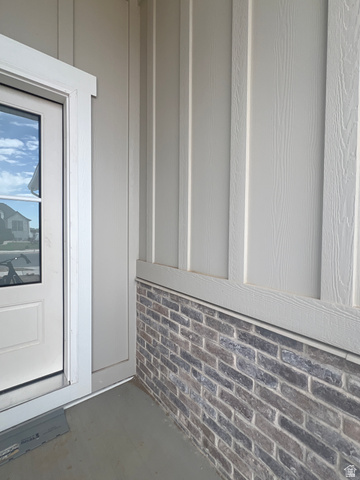 4740 West 25 North West Point, UT 84015 - Photo 2 of 15 Exterior facade showcasing board and batten siding over a brick foundation