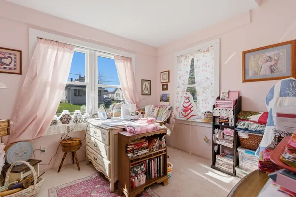 a bedroom with furniture and a large window