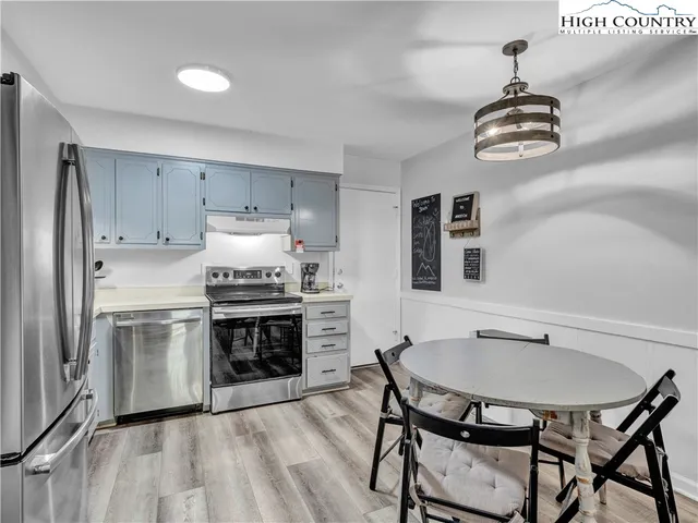 a kitchen with stainless steel appliances a stove a sink and a refrigerator